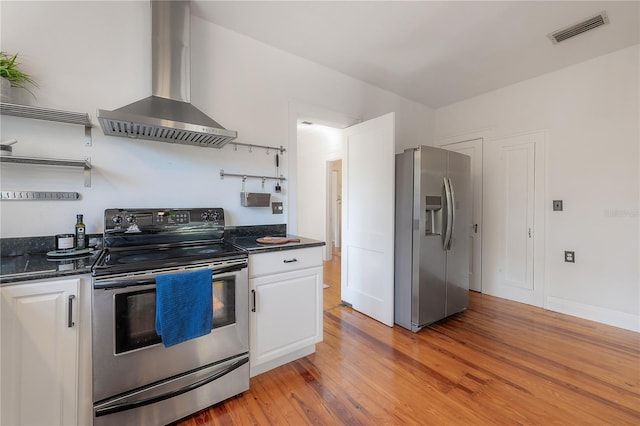 kitchen with visible vents, open shelves, appliances with stainless steel finishes, white cabinetry, and wall chimney range hood