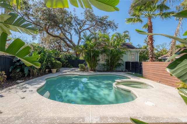 view of swimming pool featuring a fenced in pool, an in ground hot tub, a fenced backyard, and a patio area