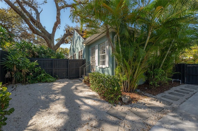 view of home's exterior featuring a gate and fence