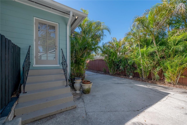 doorway to property with a patio area and fence