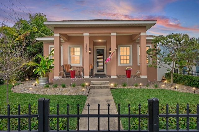 view of front facade featuring a fenced front yard, stucco siding, and a front yard