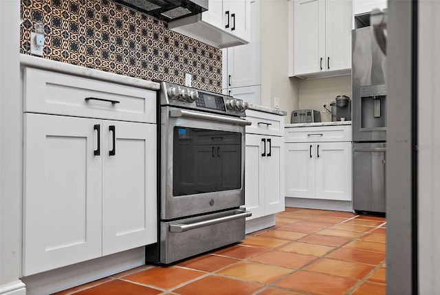 kitchen with light tile patterned floors, stainless steel electric stove, and white cabinets