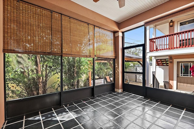 unfurnished sunroom with ceiling fan