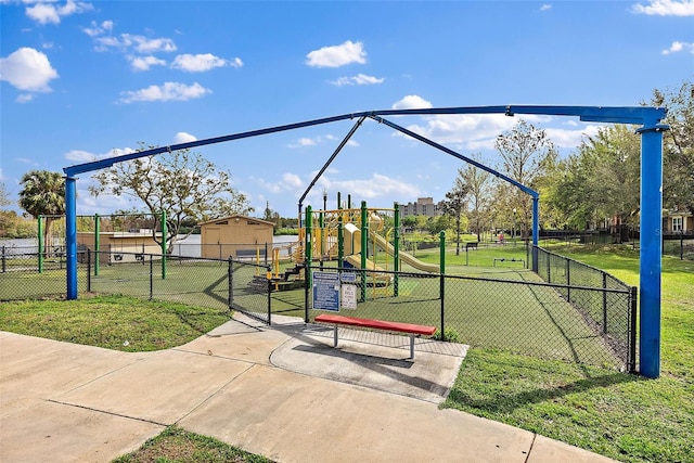 community playground featuring a lawn and fence