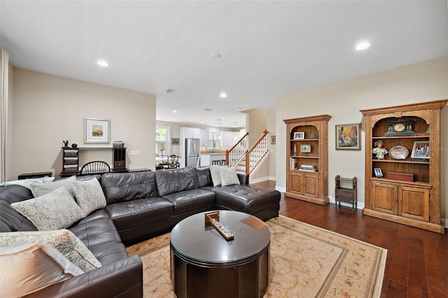 living room with recessed lighting, stairs, dark wood-type flooring, and baseboards