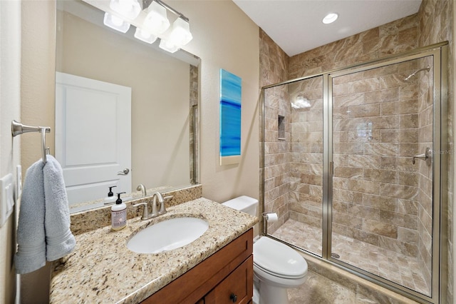 full bath featuring a shower stall, toilet, and vanity