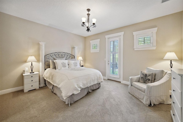 bedroom with baseboards, an inviting chandelier, and carpet flooring