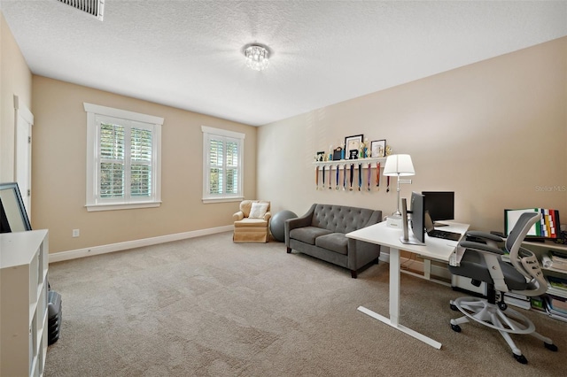 carpeted office featuring visible vents, baseboards, and a textured ceiling