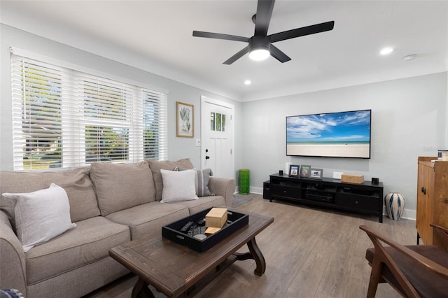 living room featuring recessed lighting, baseboards, wood finished floors, and a ceiling fan