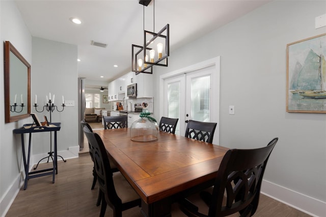 dining space with dark wood-style floors, visible vents, recessed lighting, and french doors