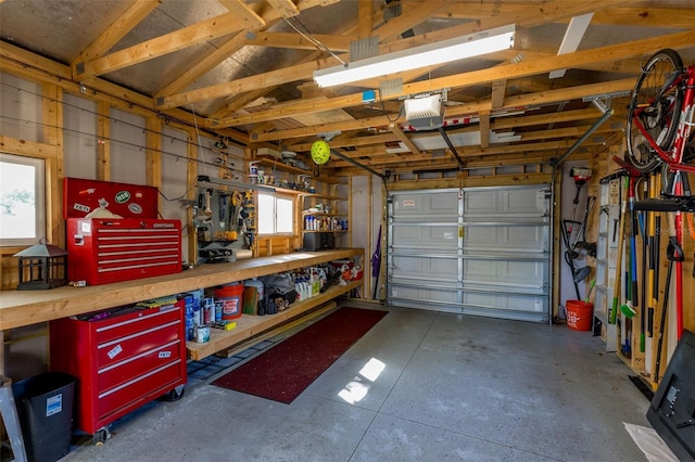 garage with a workshop area and a garage door opener