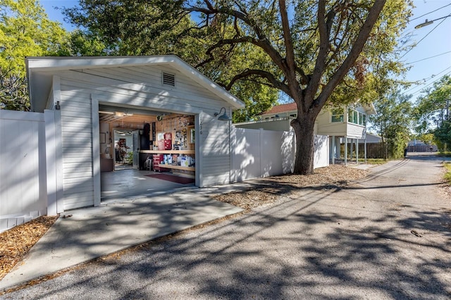 detached garage featuring fence