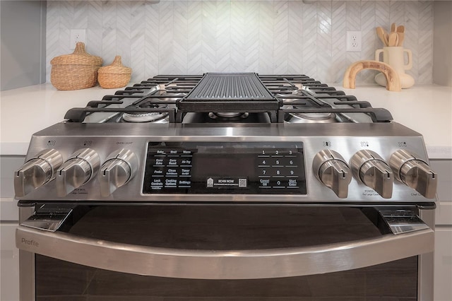 room details with tasteful backsplash and stainless steel range with gas stovetop