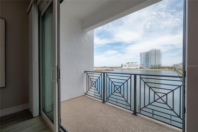 balcony with a water view and a city view