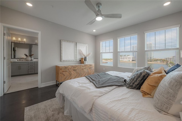 bedroom with connected bathroom, baseboards, recessed lighting, dark wood-style floors, and a sink