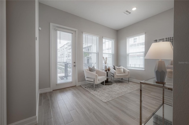 sitting room with recessed lighting, visible vents, baseboards, and wood finished floors