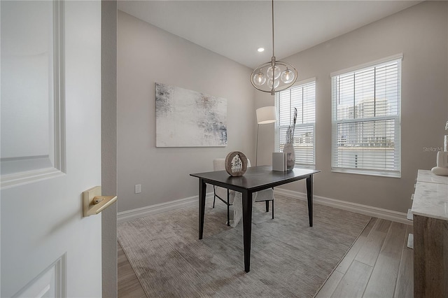 office space featuring an inviting chandelier, recessed lighting, wood finished floors, and baseboards