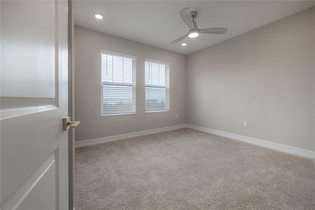 carpeted spare room featuring recessed lighting, ceiling fan, and baseboards