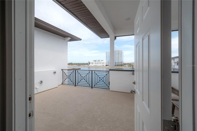 balcony featuring a view of city and a water view