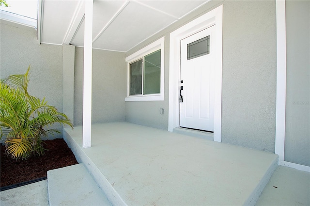 property entrance with stucco siding