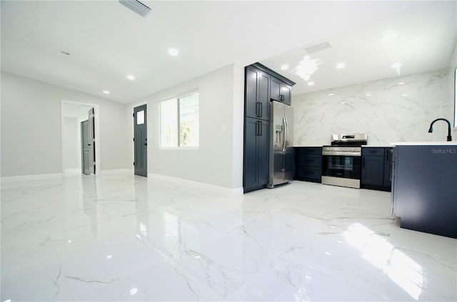 kitchen featuring visible vents, marble finish floor, recessed lighting, stainless steel appliances, and stone wall