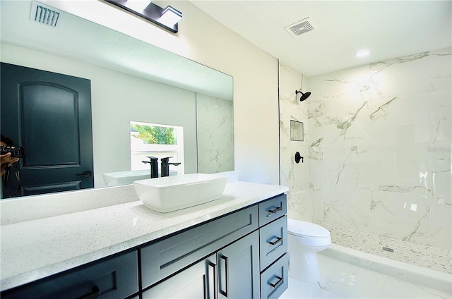 full bath with visible vents, toilet, a stall shower, and vanity