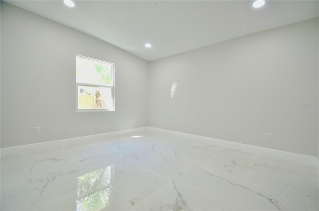 unfurnished room featuring recessed lighting, marble finish floor, and baseboards