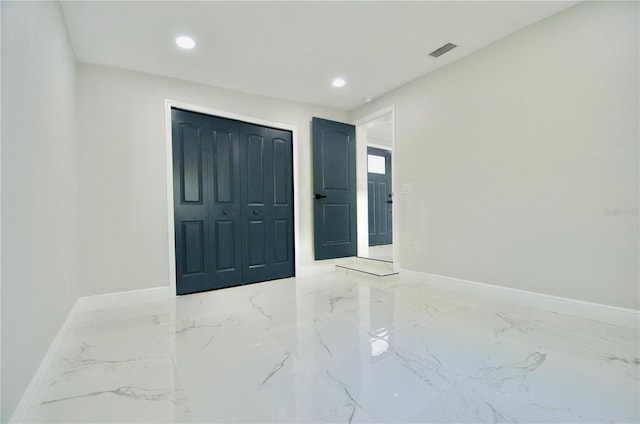 spare room with recessed lighting, visible vents, marble finish floor, and baseboards