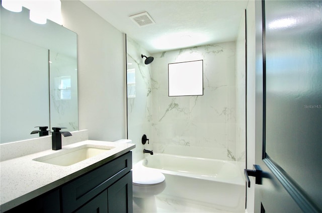 bathroom featuring vanity, visible vents, bathing tub / shower combination, toilet, and marble finish floor