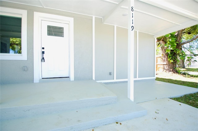 property entrance featuring stucco siding