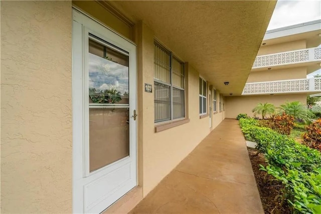 entrance to property with stucco siding