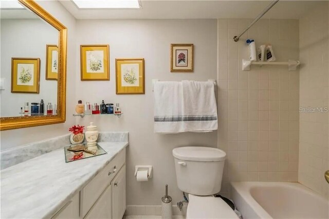 bathroom featuring vanity, toilet, and tub / shower combination