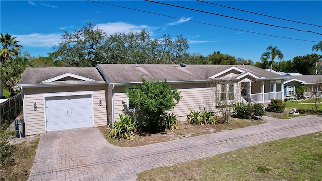 single story home with an attached garage and decorative driveway