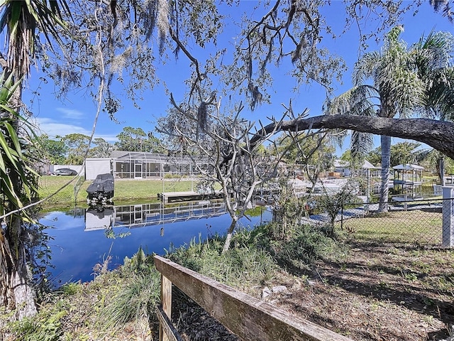 dock area featuring fence and a water view