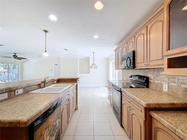 kitchen featuring tasteful backsplash, pendant lighting, light tile patterned floors, black appliances, and a sink