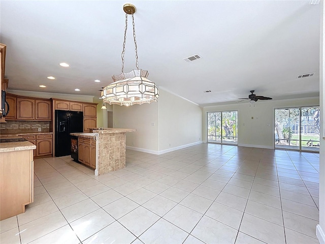 kitchen with visible vents, open floor plan, light countertops, light tile patterned floors, and black appliances