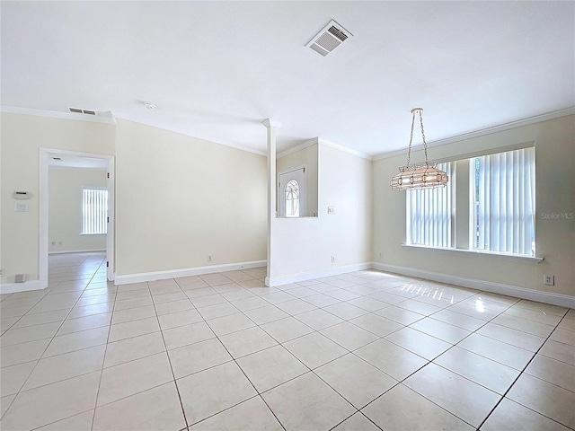 unfurnished room with light tile patterned floors, visible vents, and crown molding