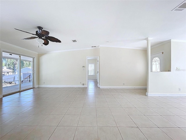 empty room with crown molding, light tile patterned floors, a ceiling fan, and visible vents