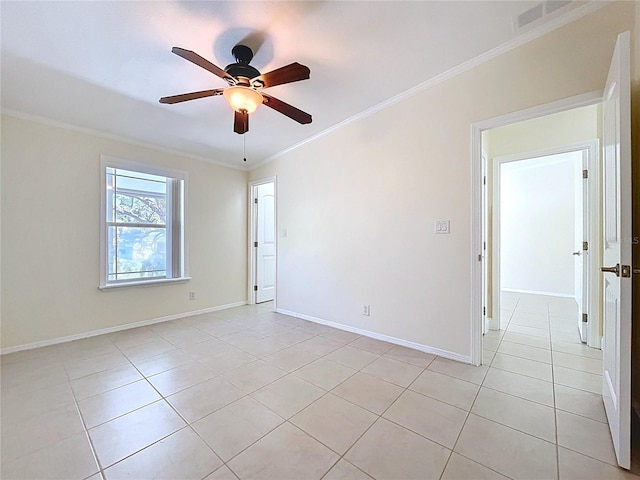 spare room with light tile patterned flooring, baseboards, ceiling fan, and ornamental molding