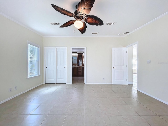 unfurnished bedroom featuring visible vents, baseboards, light tile patterned flooring, and crown molding