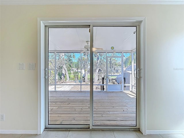 doorway to outside featuring baseboards and light tile patterned flooring