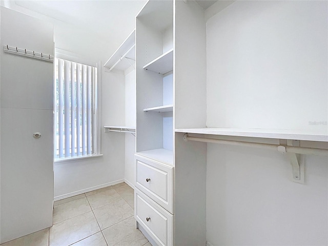 spacious closet featuring light tile patterned flooring