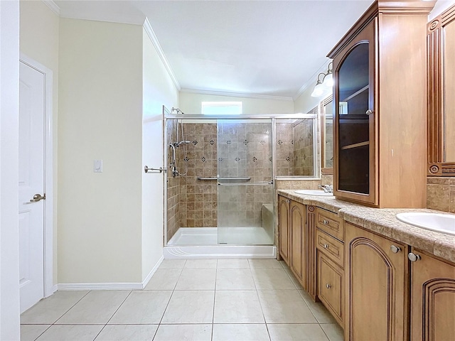 full bath with tile patterned floors, crown molding, double vanity, and a shower stall