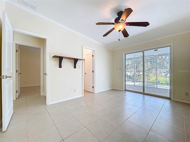 spare room with ceiling fan, light tile patterned flooring, and ornamental molding