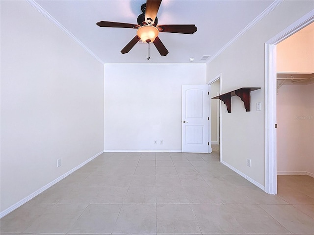 unfurnished bedroom featuring a walk in closet, baseboards, ceiling fan, and crown molding