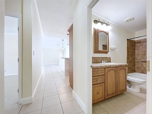 bathroom featuring toilet, ornamental molding, vanity, and tile patterned flooring