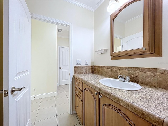 bathroom with tile patterned floors, visible vents, crown molding, baseboards, and vanity