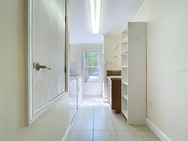 bathroom featuring vanity, baseboards, ornamental molding, tile patterned floors, and independent washer and dryer