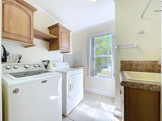 clothes washing area featuring light tile patterned flooring, cabinet space, ornamental molding, and separate washer and dryer