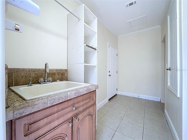 bathroom with tile patterned floors, visible vents, ornamental molding, baseboards, and vanity